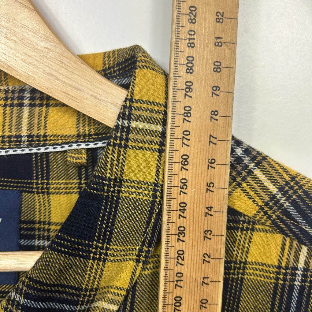 Yellow and navy plaid fabric detail view with measuring tape