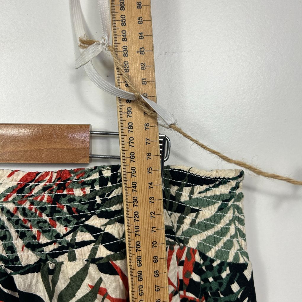 Multicolored patterned fabric detail view with measuring tape