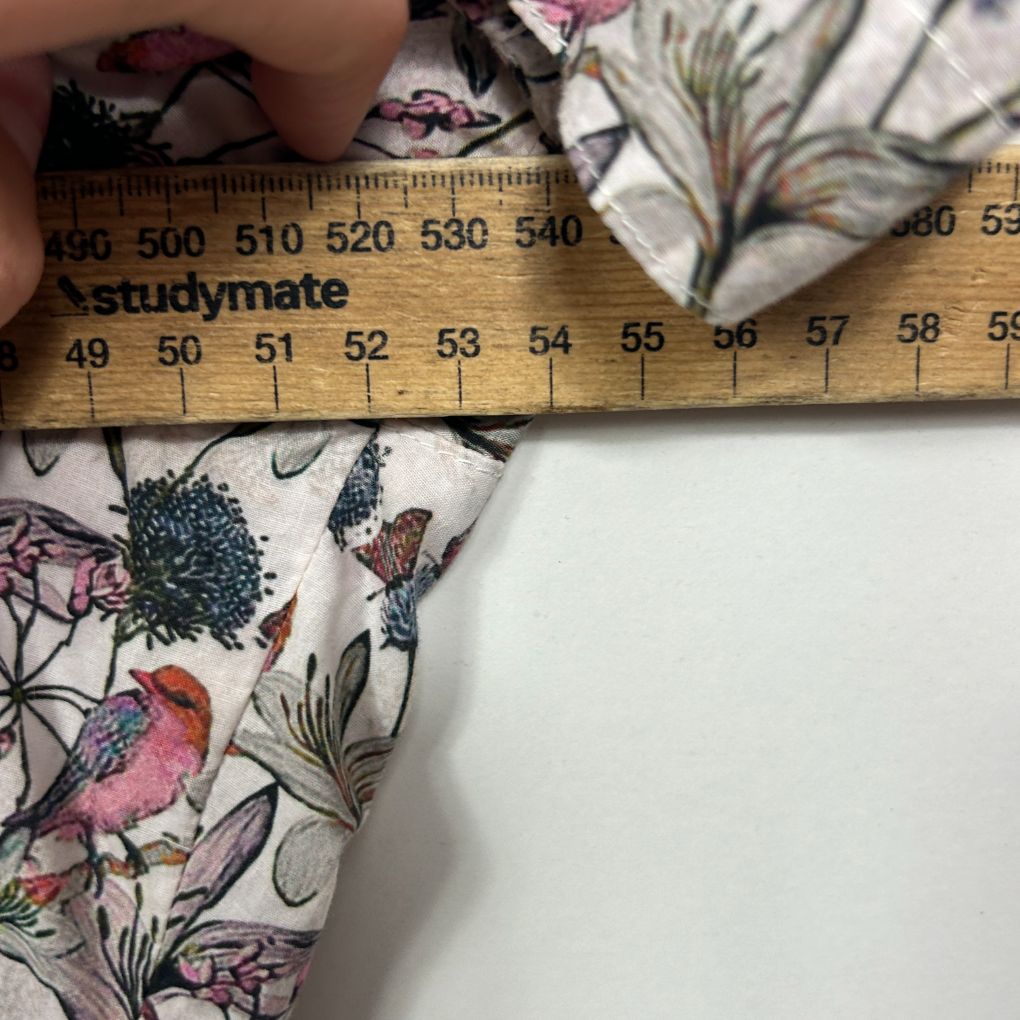 Floral fabric detail view with measurement ruler