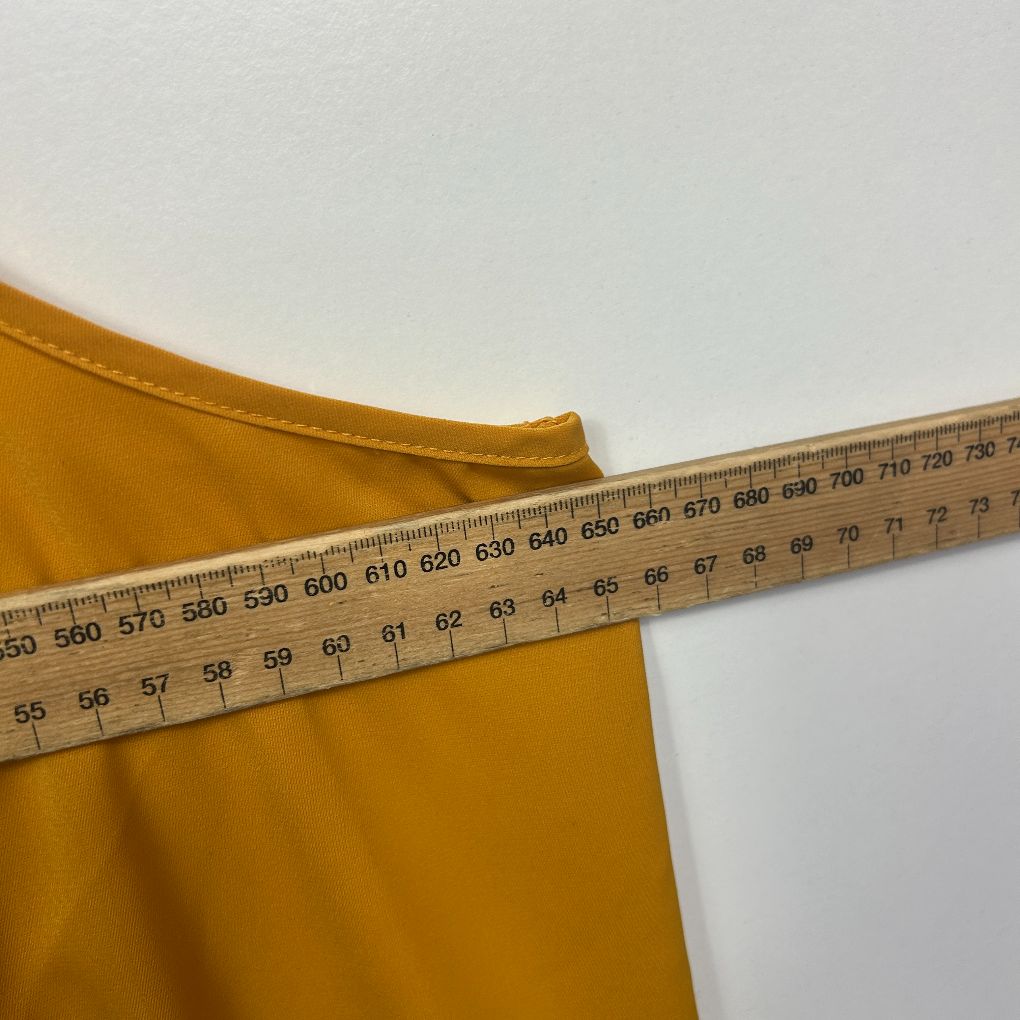 Yellow fabric with measuring tape detail view