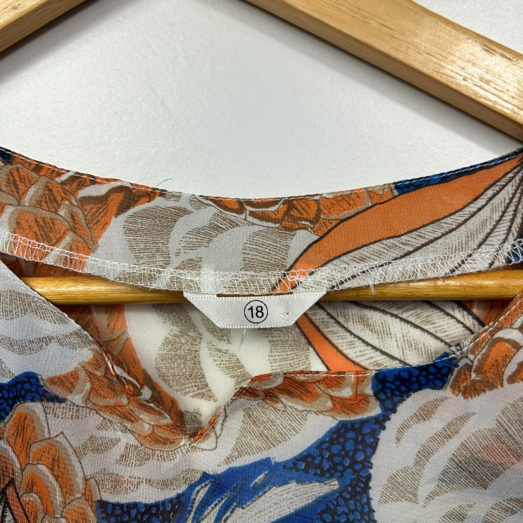 Orange and blue floral print blouse on wooden hanger detail view