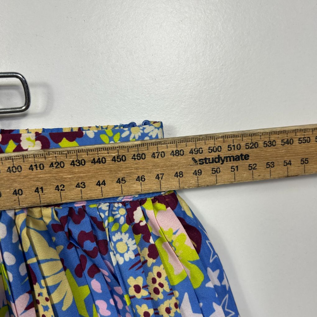 Colorful floral shorts detail view with measuring tape