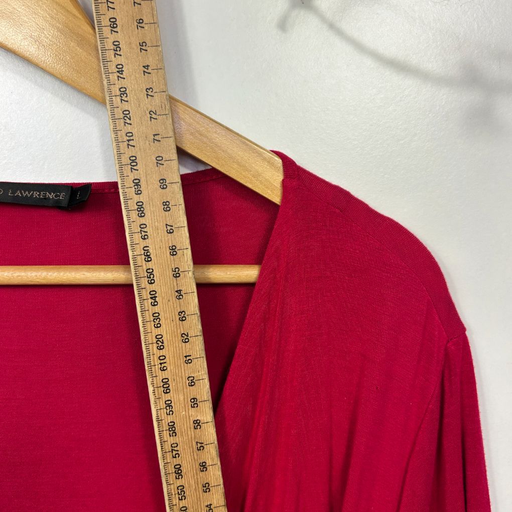 Red long sleeve top front view with measuring tape