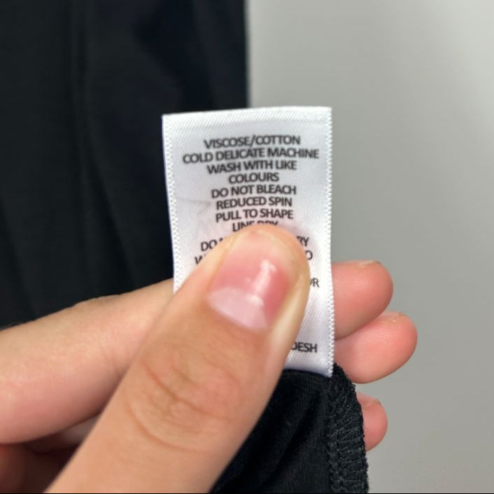 Black garment care label detail view