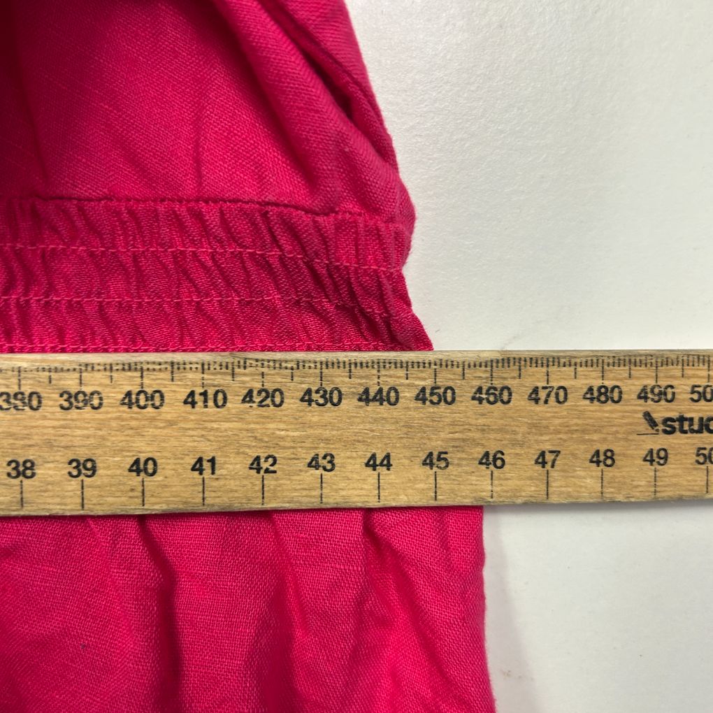 Pink fabric with measurement tape detail view