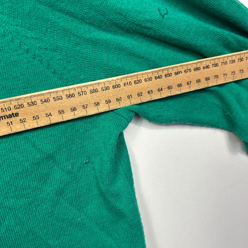 Green fabric with measuring tape detail view