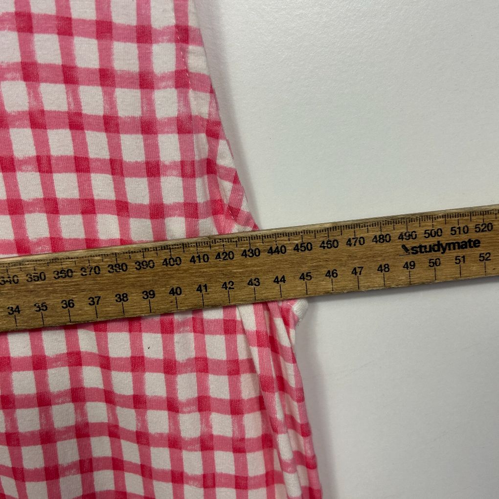 Pink and white gingham fabric with measuring tape detail view