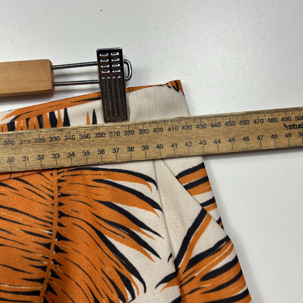 Orange and black tiger stripe fabric detail view with measuring tape