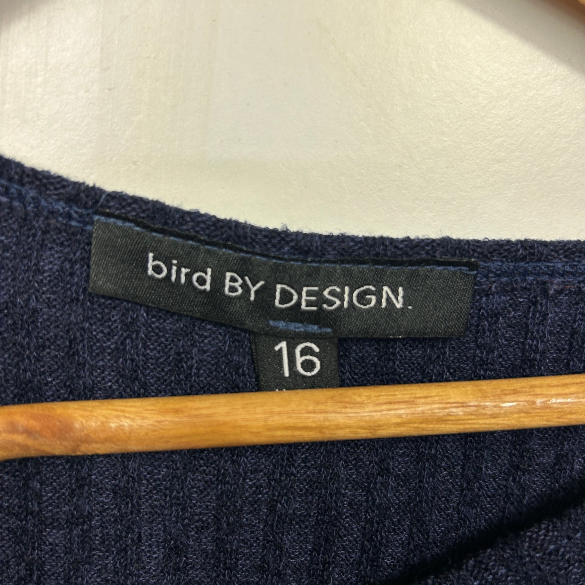 Navy blue long sleeve top label detail view
