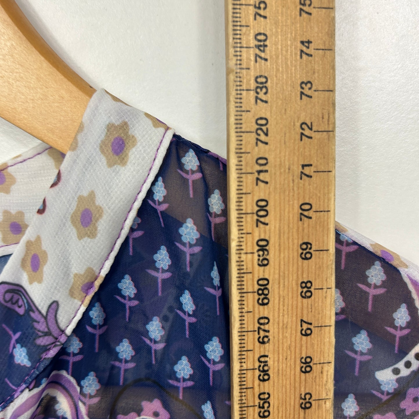 Purple floral dress detail view with ruler