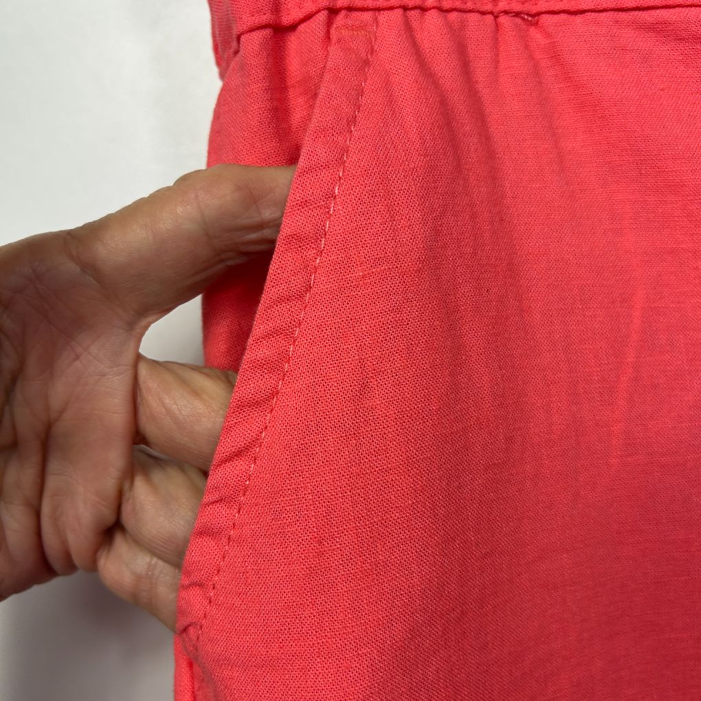 Red garment detail view showing seam and fabric texture