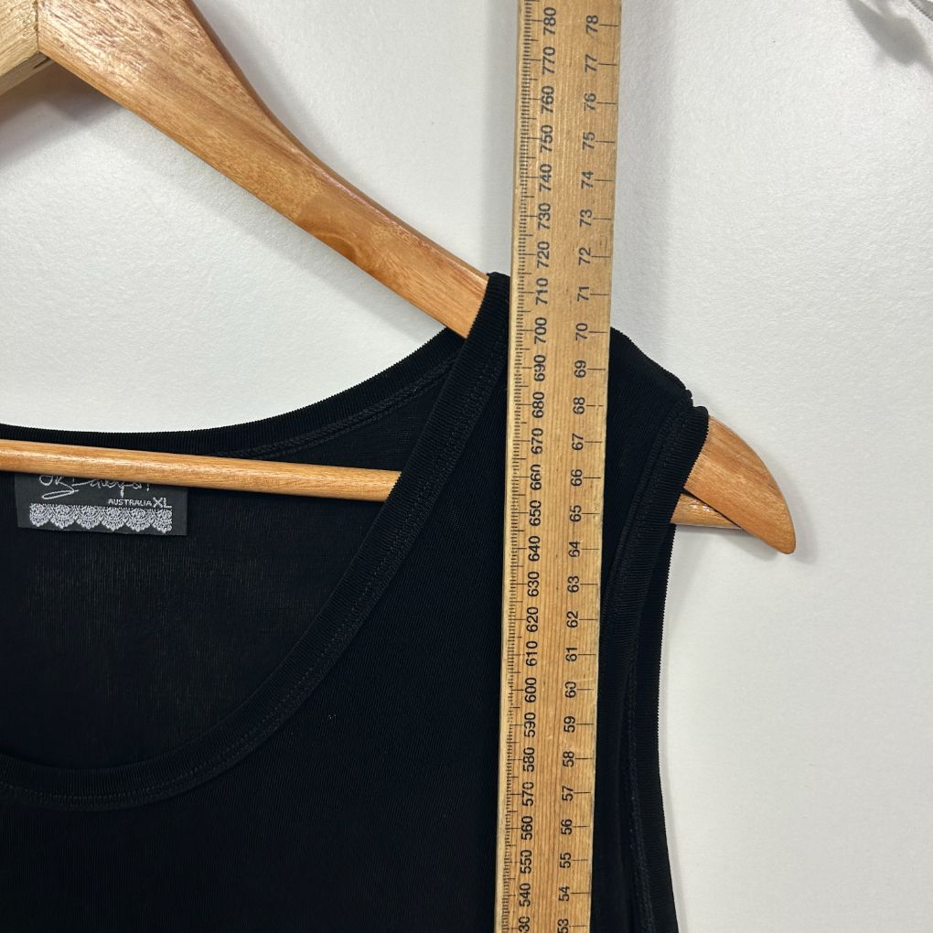 Black tank top front view with wooden hanger and measuring tape